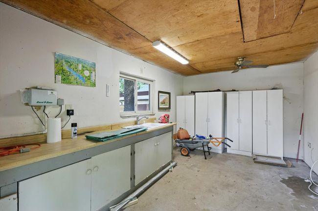 Miscellaneous room featuring concrete flooring and ceiling fan | Image 33