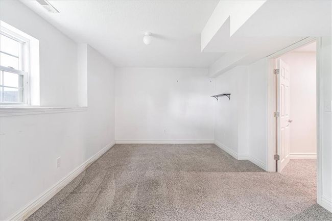 Spare room with baseboards, carpet flooring, and visible vents | Image 41