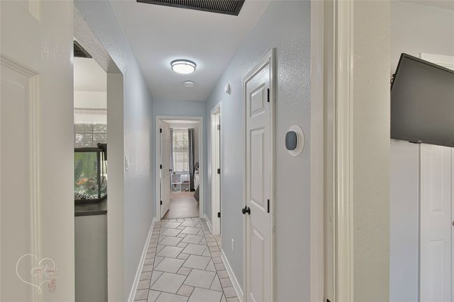 Hall featuring baseboards and light tile patterned floors | Image 12