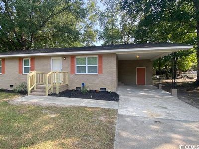 Ranch-style home featuring a carport | Image 1