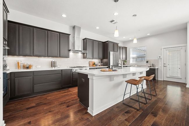 The kitchen features Bertazzoni double wall ovens and a five-burner gas cooktop—everything you need for cooking like a pro, right at your fingertips | Image 13