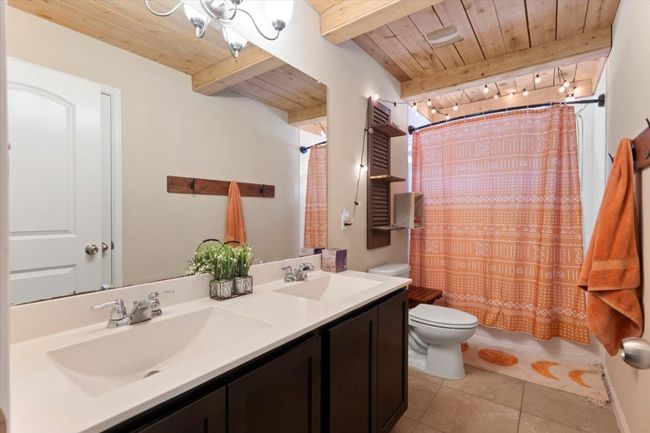 Secondary upstairs full bathroom with double vanity and bathtub/shower combo. | Image 30
