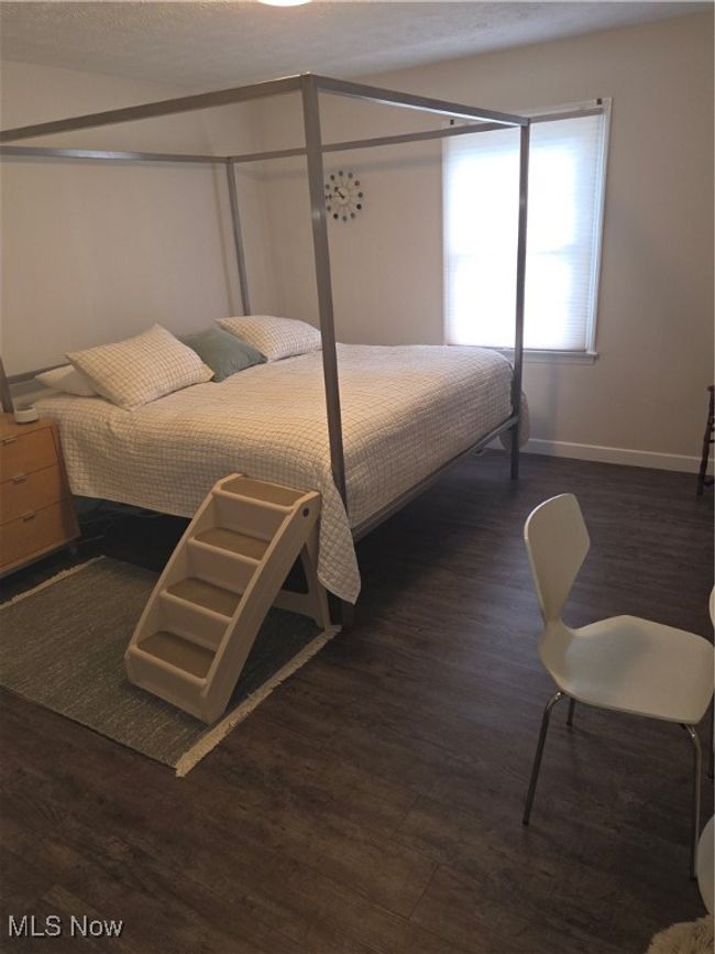 Bedroom featuring baseboards and wood finished floors | Image 19
