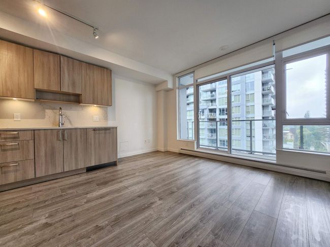 Kitchen featuring track lighting, modern cabinets, healthy amount of natural light, and wood finished floors | Image 4