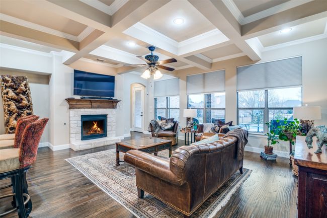 Living room additionally features luxury handscraped hardwood flooring and large windows looking over the outdoor oasis. | Image 12
