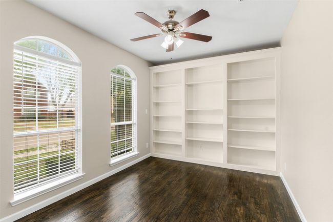 Unfurnished room with baseboards, ceiling fan, and dark wood finished floors | Image 28