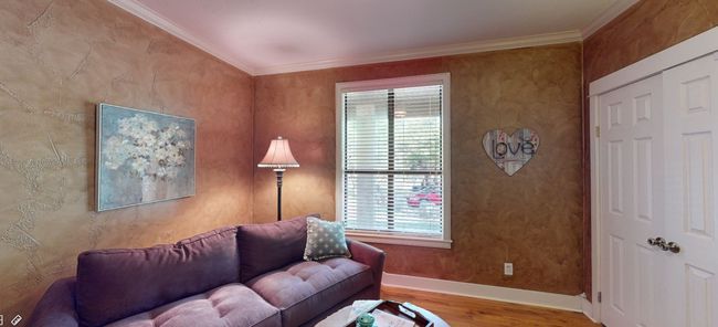 Main house second bedroom with wood flooring, baseboards, crown molding, and ceiling fan | Image 18