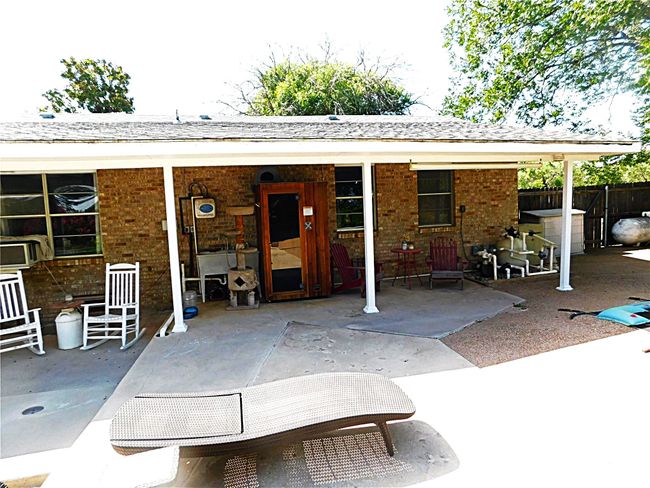 Rear view of house featuring a patio area, brick siding, and roof with shingles | Image 34