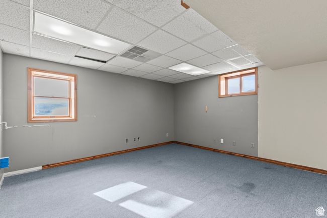 Carpeted empty room featuring baseboards and a paneled ceiling | Image 16