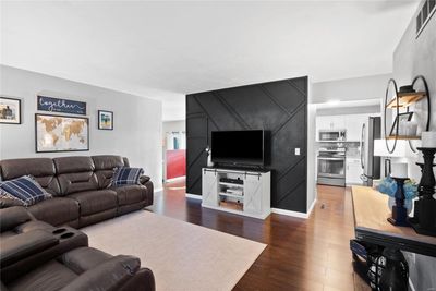 Living room with dark wood-type flooring | Image 2