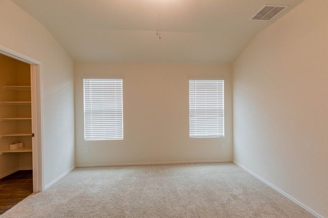 Carpeted empty room featuring lofted ceiling, healthy amount of natural light, and baseboards | Image 9