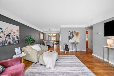 Living room featuring hardwood / wood-style floors and an inviting chandelier | Image 2