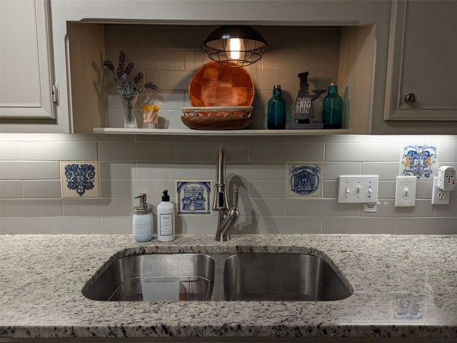 Kitchen view of tasteful backsplash and light stone countertops | Image 16