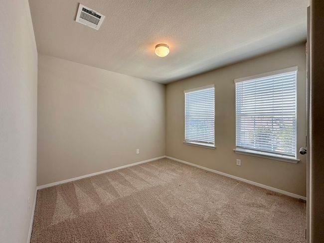 Spare room featuring carpet and a textured ceiling | Image 26