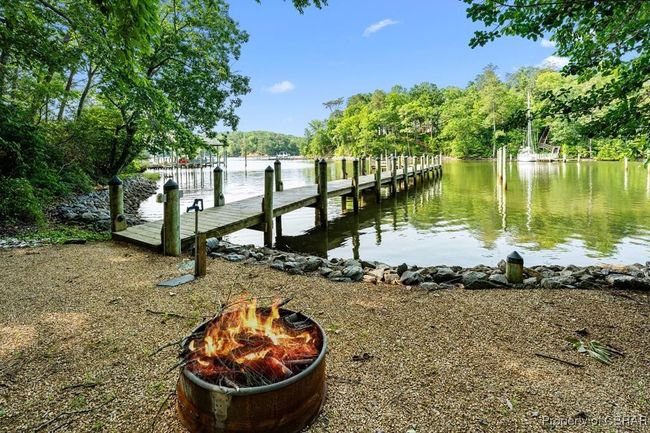 Dock area featuring an outdoor fire pit and a water view | Image 15