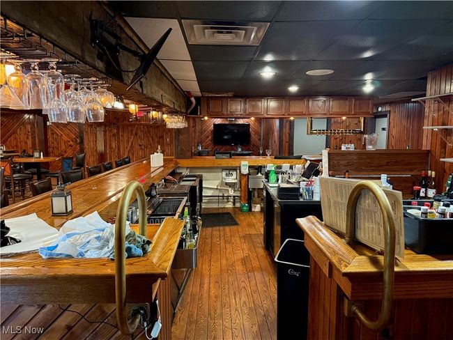 Kitchen with hardwood / wood-style flooring and wooden walls | Image 24