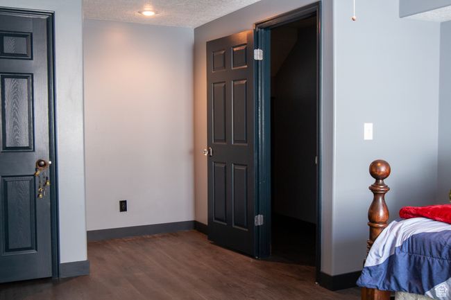 Bedroom with a textured ceiling, baseboards, and new LVP flooring | Image 28