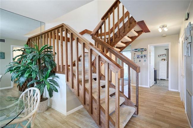 Stairs with hardwood / wood-style tile floors | Image 4