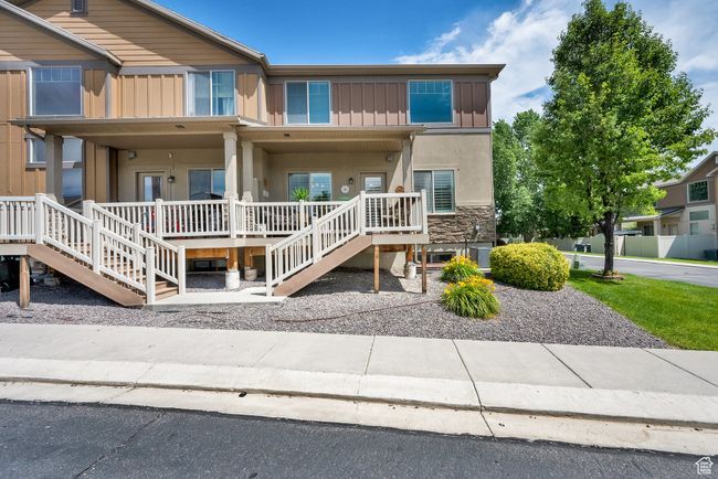 View of front of home featuring a porch, board and batten siding, stairs, and stucco siding | Image 30