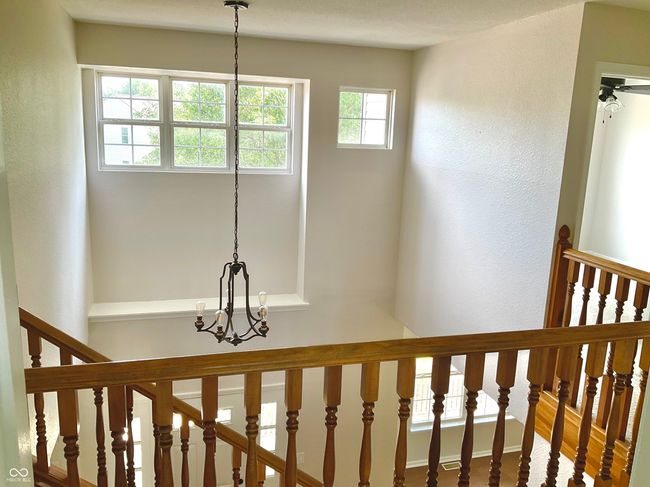 Bright and open upper hallway with new carpet and paint. | Image 35