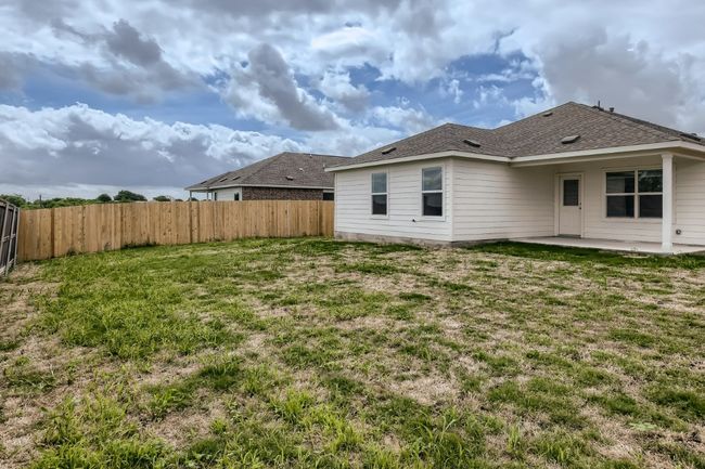 Rear view of property with a patio area and a shingled roof | Image 17