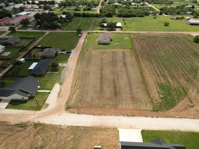 Aerial view of sparsely populated area with farmland | Image 5