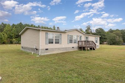 Rear view of property featuring a lawn and a wooden deck | Image 3