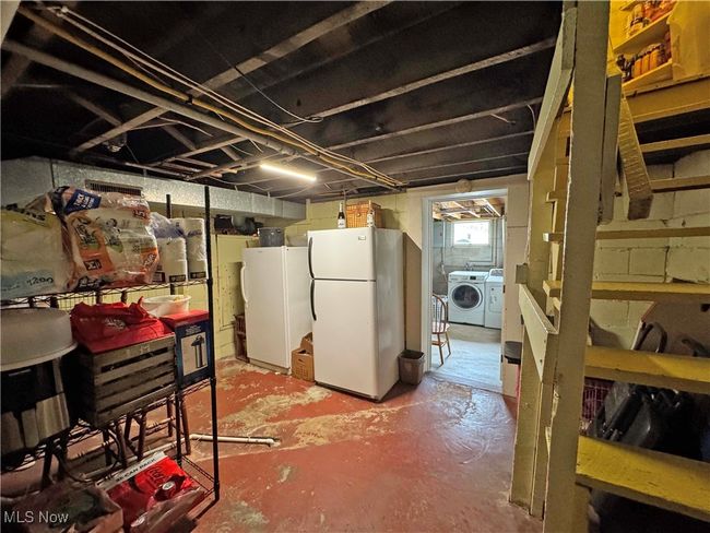 Below grade area featuring freestanding refrigerator and washer and dryer | Image 40