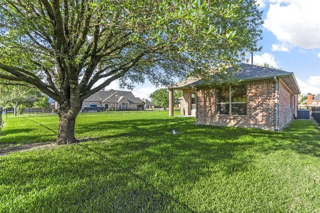 Beautiful spacious back yard with sprawling gorgeous tree adorning this home. | Image 32
