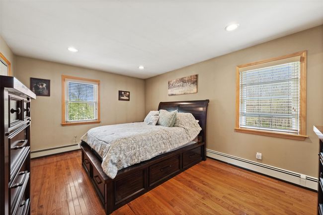 Bedroom featuring baseboard heating, recessed lighting, and light wood-style flooring | Image 18