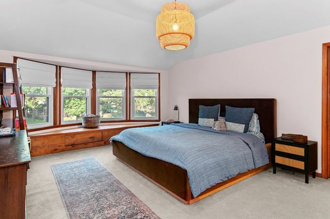 Carpeted bedroom featuring lofted ceiling | Image 28