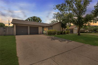 Single story home with a garage and a yard | Image 2