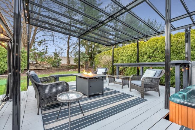 Wooden deck with a fire pit and a pergola | Image 37