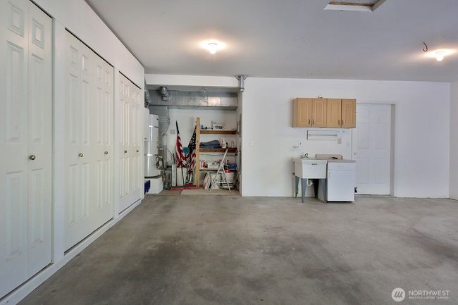 Oversized 2 Car garage with built in cabinets and a sink. | Image 27
