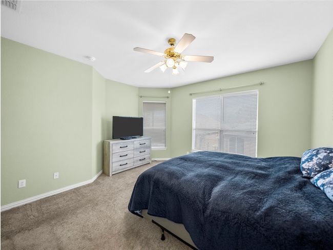 Bedroom with carpet, visible vents, ceiling fan, and baseboards | Image 18