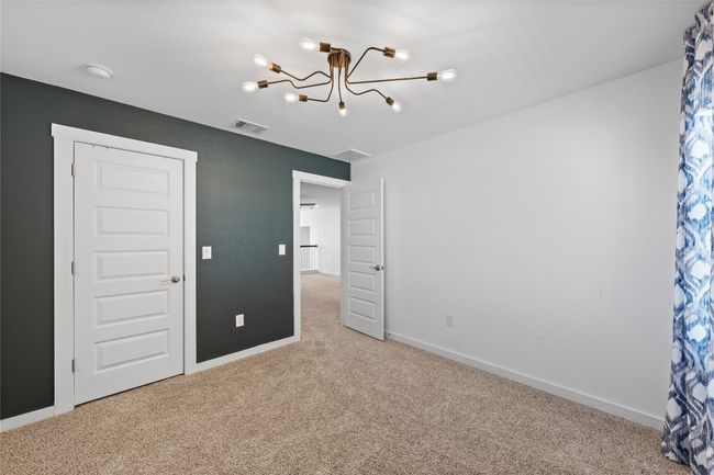 Unfurnished bedroom featuring baseboards, visible vents, carpet flooring, and a chandelier | Image 31