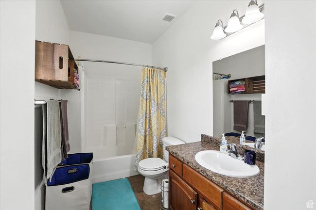 Bathroom with vanity, shower / bath combination with curtain, and tile patterned floors | Image 16