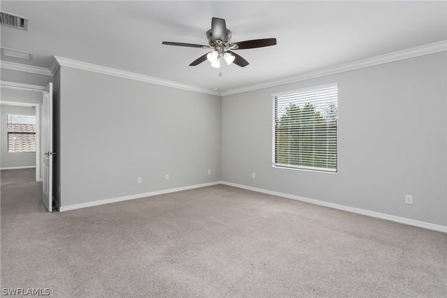 Carpeted empty room with ceiling fan and ornamental molding | Image 22