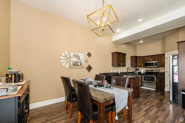 Dining room with a chandelier, baseboards, dark wood-type flooring, visible vents, and recessed lighting | Image 11