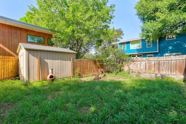 View of yard with a fenced backyard, an outbuilding, and a storage shed | Image 23