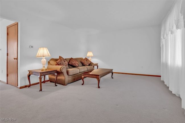 Living room with carpet flooring and baseboards | Image 7
