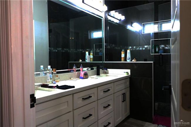 Full bathroom featuring double vanity and a sink | Image 14