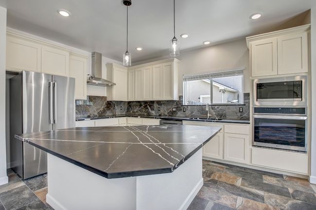 Kitchen with stainless steel appliances, quartz countertops, backsplash, and recessed lighting | Image 27