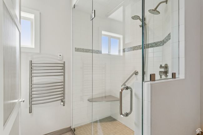 Bathroom with radiator, a stall shower, and a towel warmer | Image 20