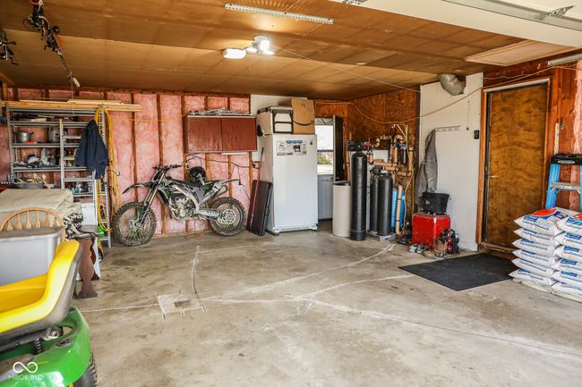 garage with freestanding refrigerator | Image 35