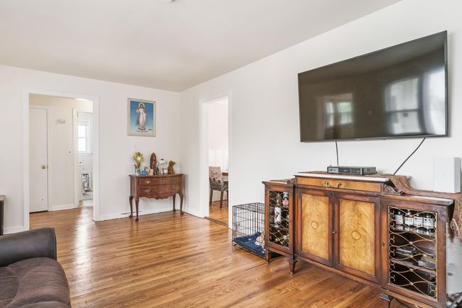 Living area with baseboards and light wood-style floors | Image 9
