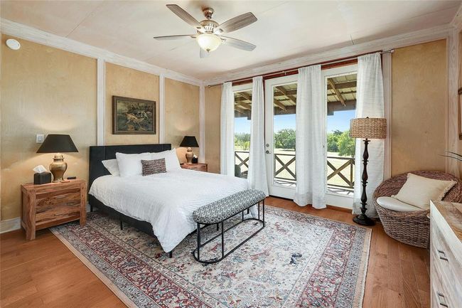 Bedroom featuring french doors, wood finished floors, ornamental molding, and access to exterior | Image 17