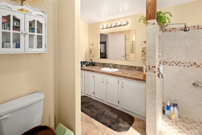 Full bath featuring vanity and a tile shower | Image 25