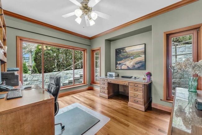 Office space with ornamental molding, a wealth of natural light, baseboards, and light wood-type flooring | Image 23