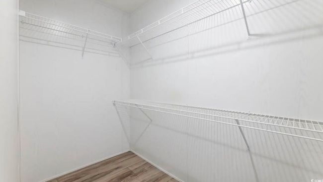 Walk in closet with wood finished floors | Image 31